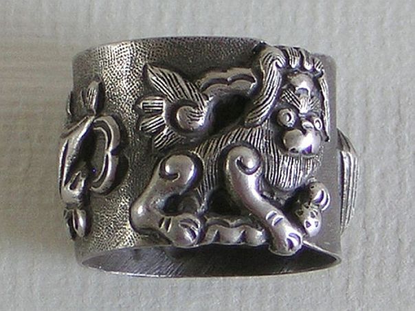 Ring with a lion and auspicious objects – (7498)